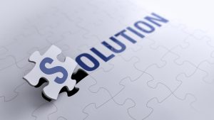 A white jigsaw with the word solution on it