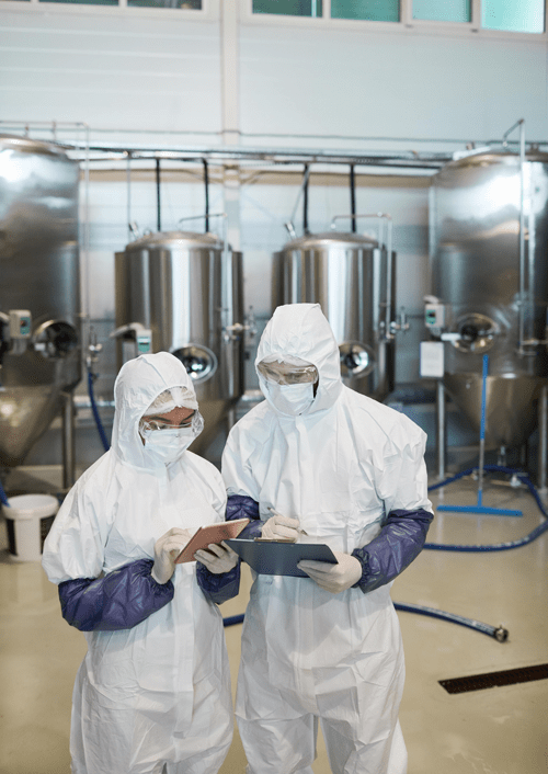 Two Chemical Plant Workers Reviewing Takt Time Calculation