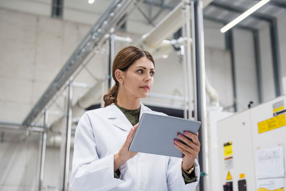 Female worker reviewing manufacturing upon introduction to statistical process control