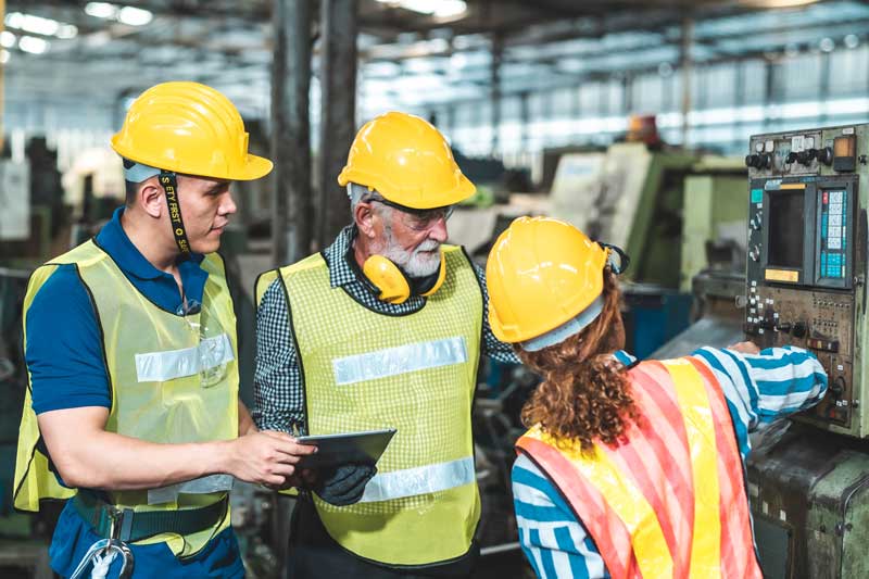 Factory group of workers looking at their production counters