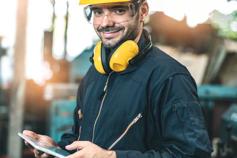 Male factory worker looking at OEE report