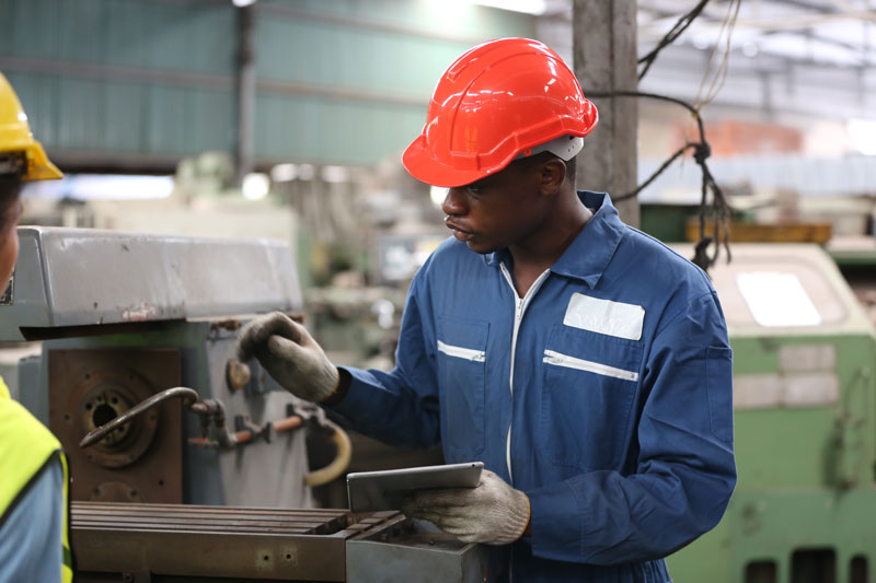 Industrial factory employee working to eliminate waste