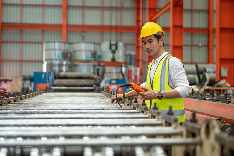 MTTR results being examined by male manufacturing staff member