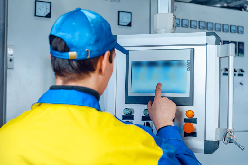 Man worker in manufacturing plant reviewing short interval control process